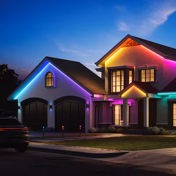 Home roofline lit with Govee permanent lighting during a cold winter evening
