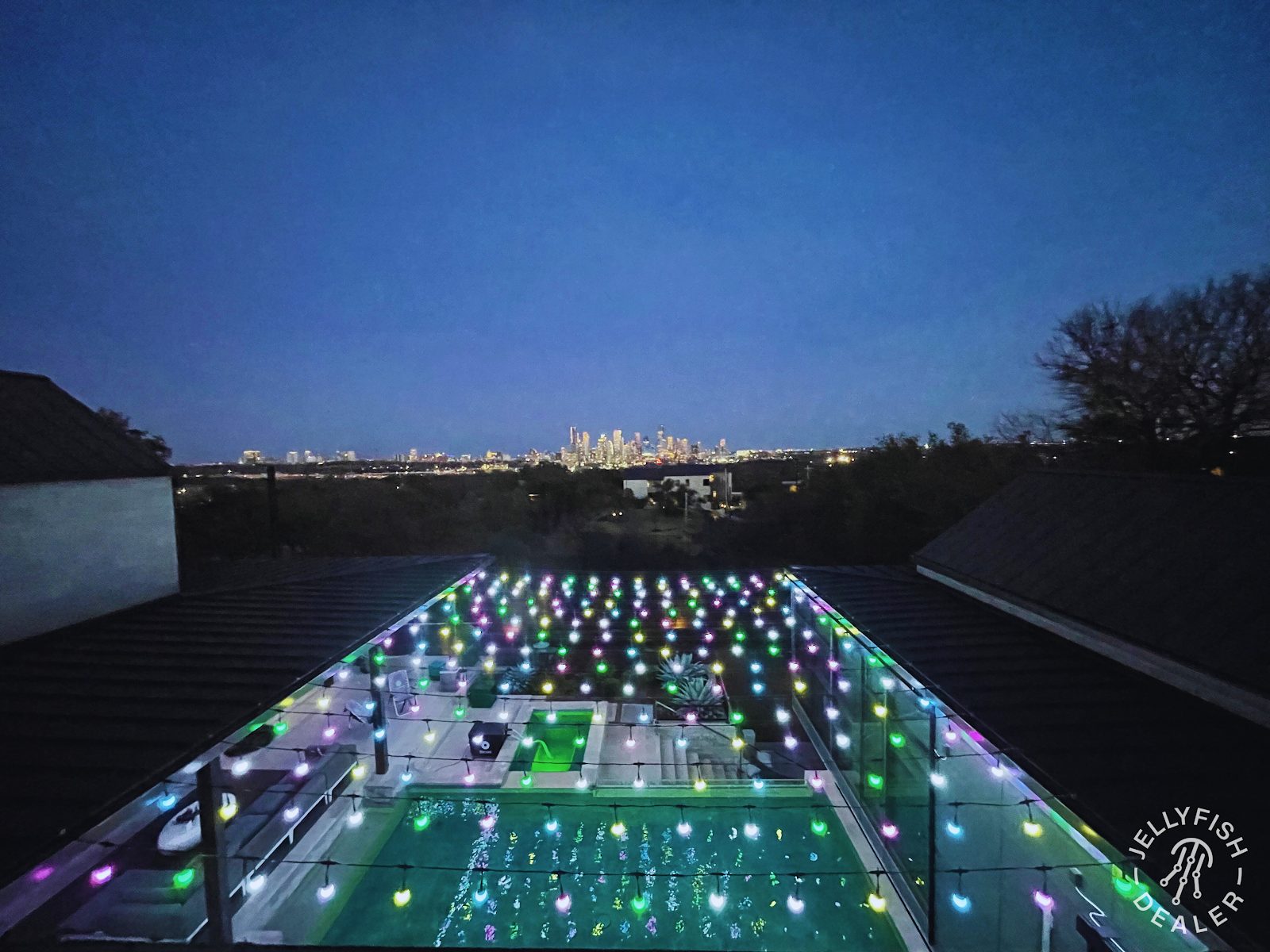 Criss-cross patio light pattern spanning a backyard seating area