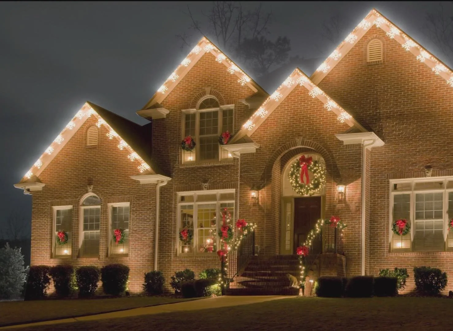 Sylvania home decorated with professional holiday light installation along the roofline