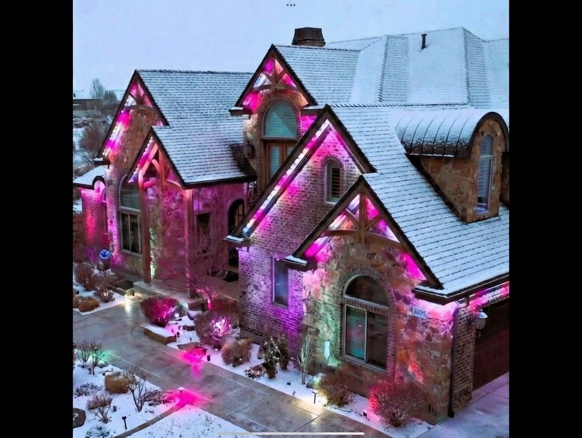 Home exterior with separate zones of Jellyfish lighting glowing different warm tones